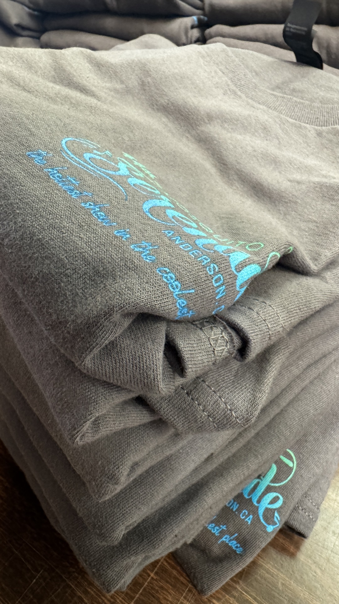 A stack of custom-printed hoodies and sweatshirts