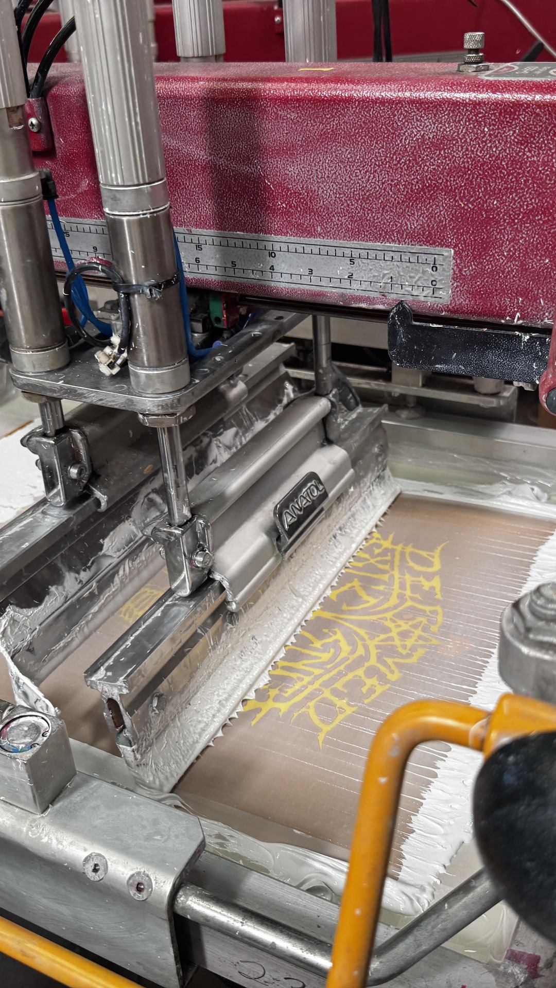Screen printing in action on the press at Apple Jacks
